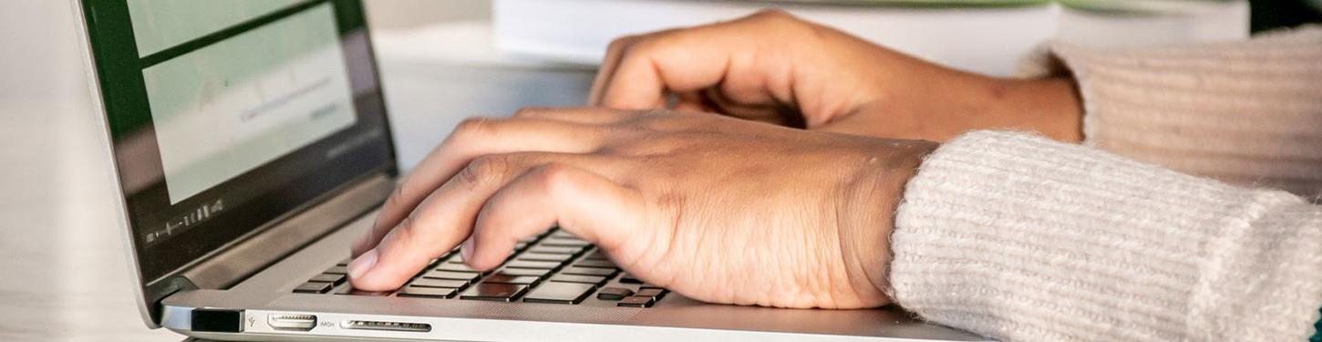 a student types on a laptop